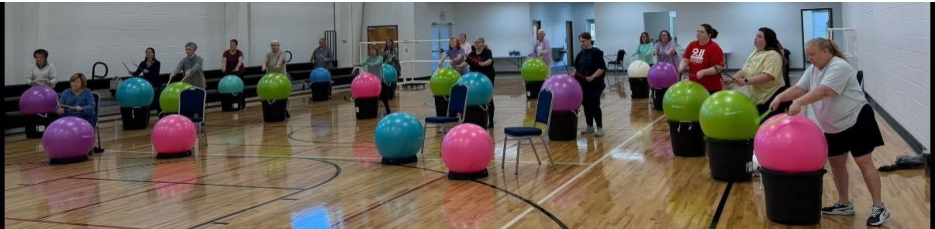 Drums Alive class participants with yoga balls